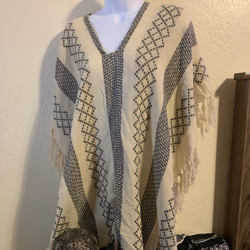 Cream and grey knit poncho with fringe